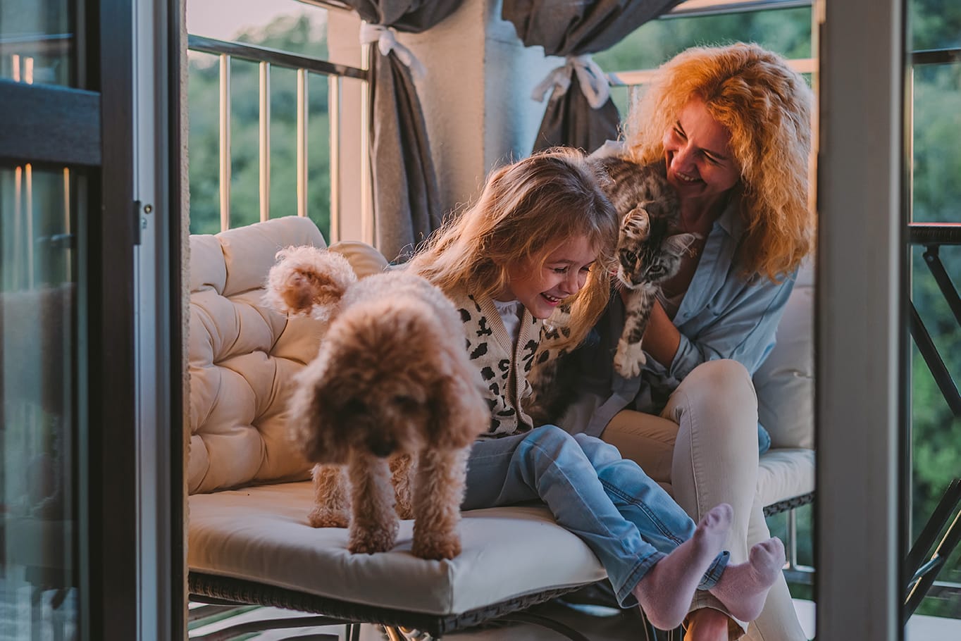 mother and daughter playing with a dog and cat in austin texas